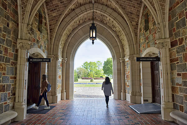 Student walking through Ford Building hallway